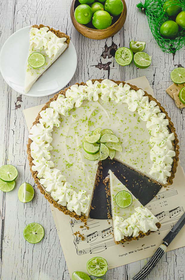 A key lime pie with a slice cut out