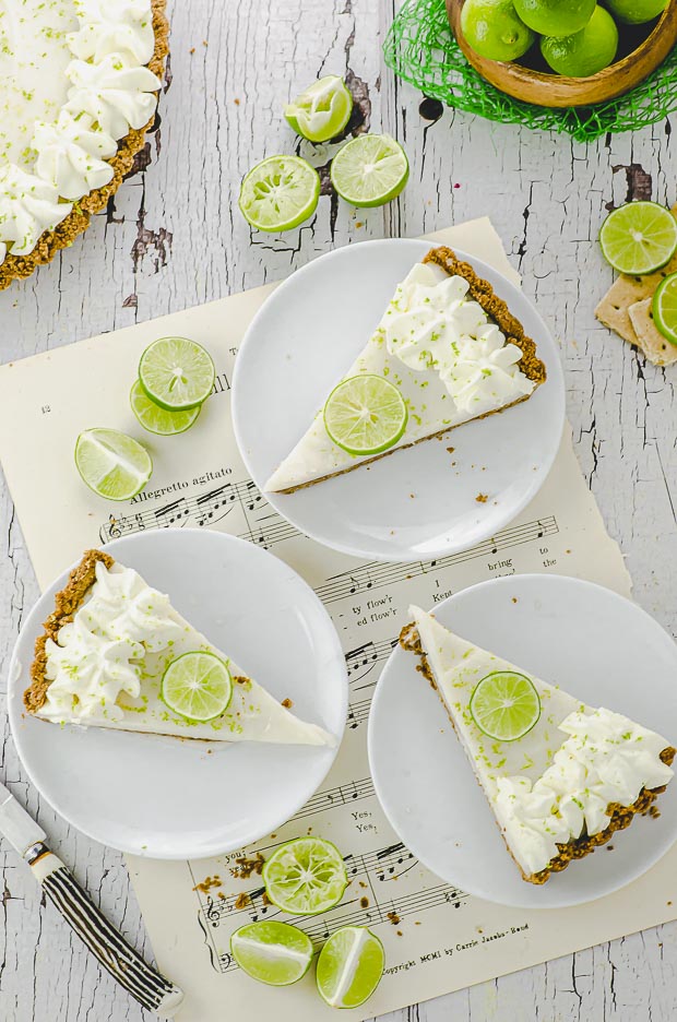 Close up of Three slices of key lime pie tart on 3 white plates
