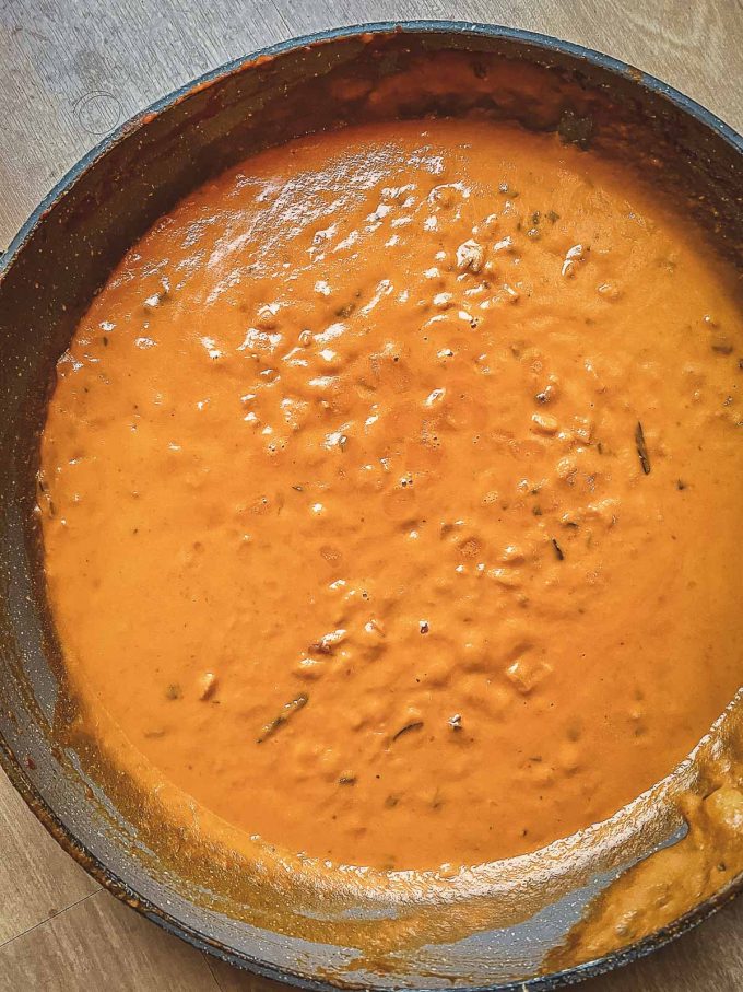 Pumpkin pasta sauce cooking in a skillet