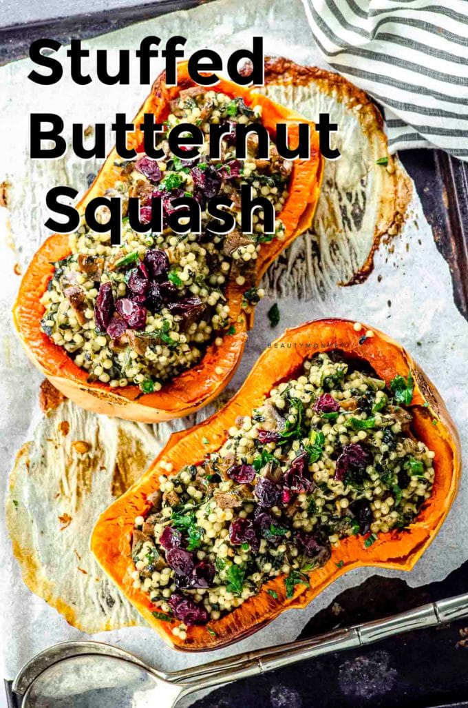 Overhead view of two roasted butternut squash halves stuffed with Israeli couscous and topped with dried cranberries