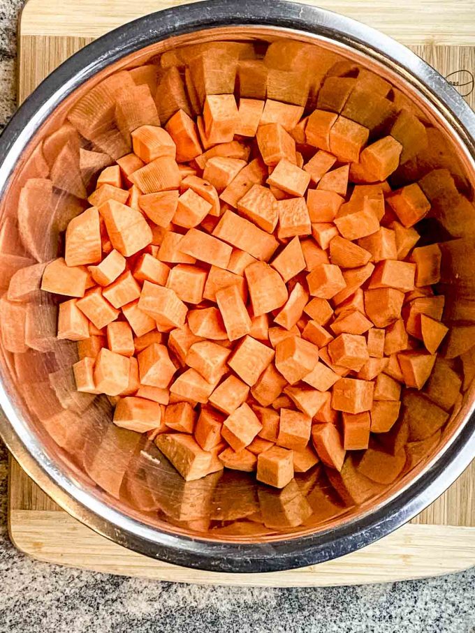 Cut up uncooked sweet potato cubes in a bowl