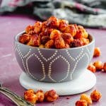 Close up side view of a grey bowl filled with moroccan spiced chickpeas