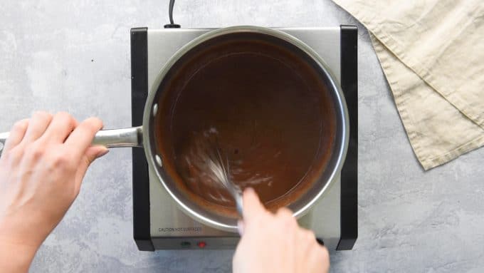 Stirring Whiskey cream sauce in a pan