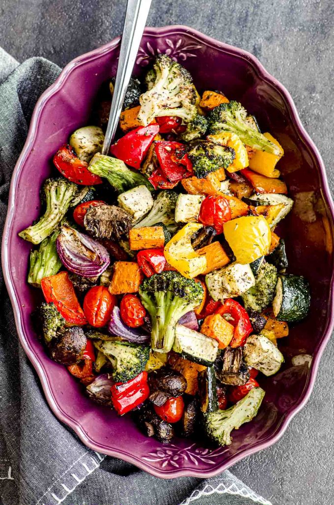 Oven roasted vegetables on a purple serving dish.