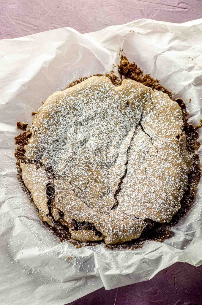 Overhead view of a flourless chocolate cake dusted with confectioner's sugar