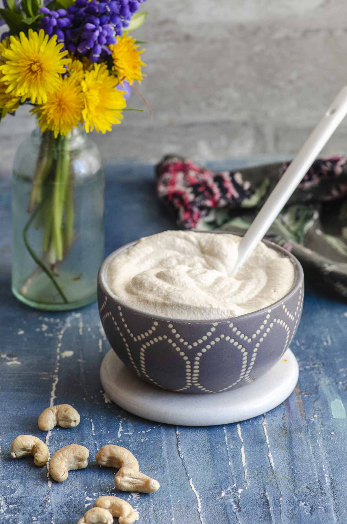 Side view of a small grey bowl filled with cashew cream