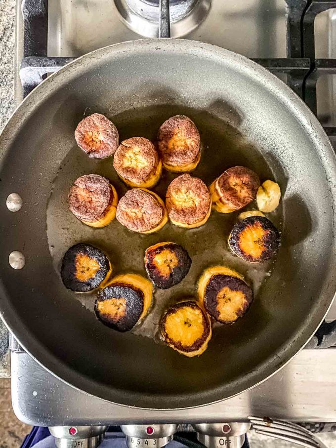 Cooked plantain slices on a skillet