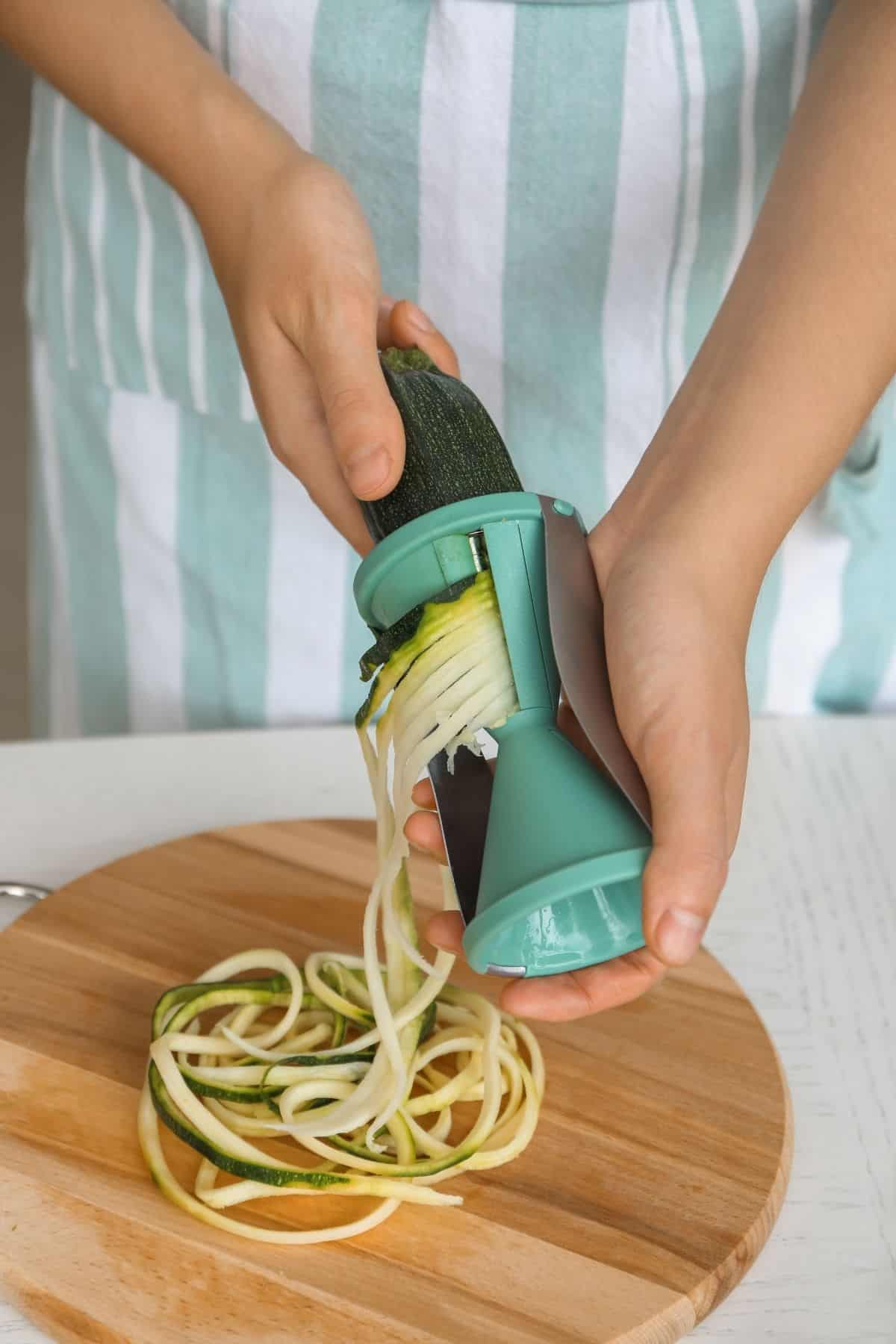 Making zucchini noodles with a hand spiralizer
