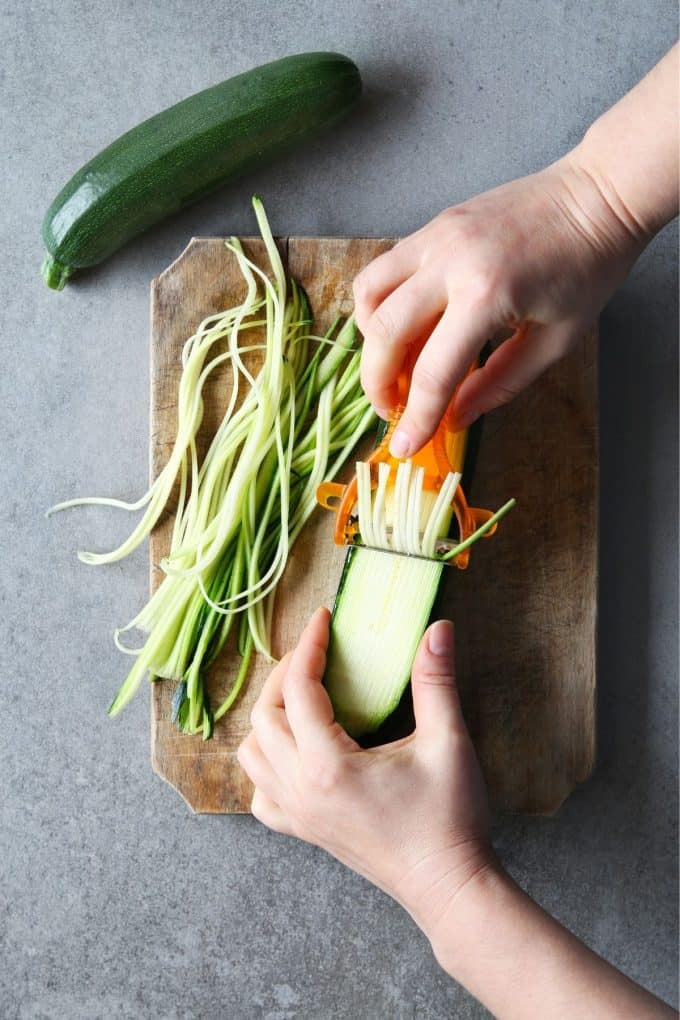 Making zucchini noodles with a julienne peeler