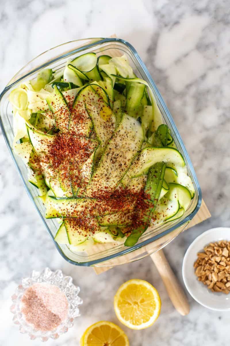 Zucchini salad season with spices before mixing