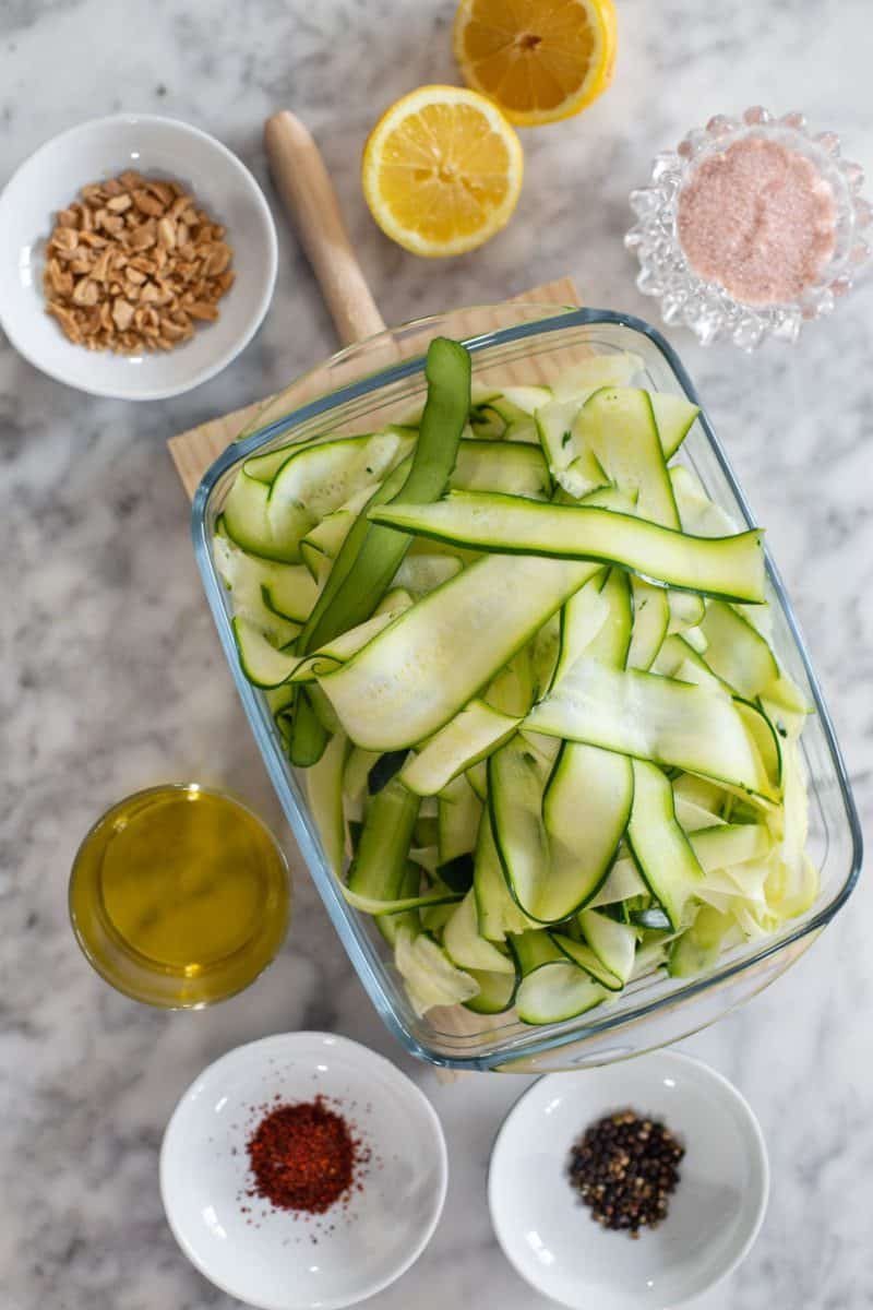 A glass baking dish with zucchini ribbons