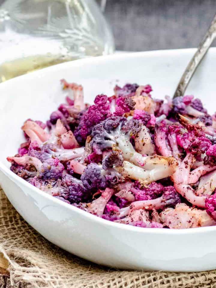 close up view of a bowl of roasted purple cauliflower