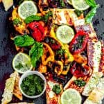 A board of sweet roasted peppers with sliced baguette, pesto and grilled halloumi cheese