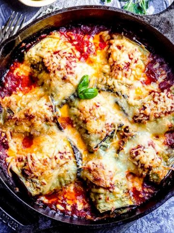 an overhead view of eggplant rollatini in a cast iron