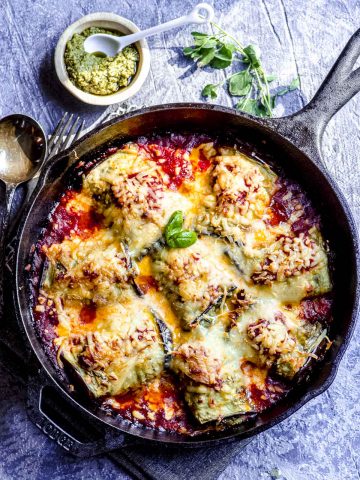 an overhead view of baked eggplant rollatini in a cast iron skillet