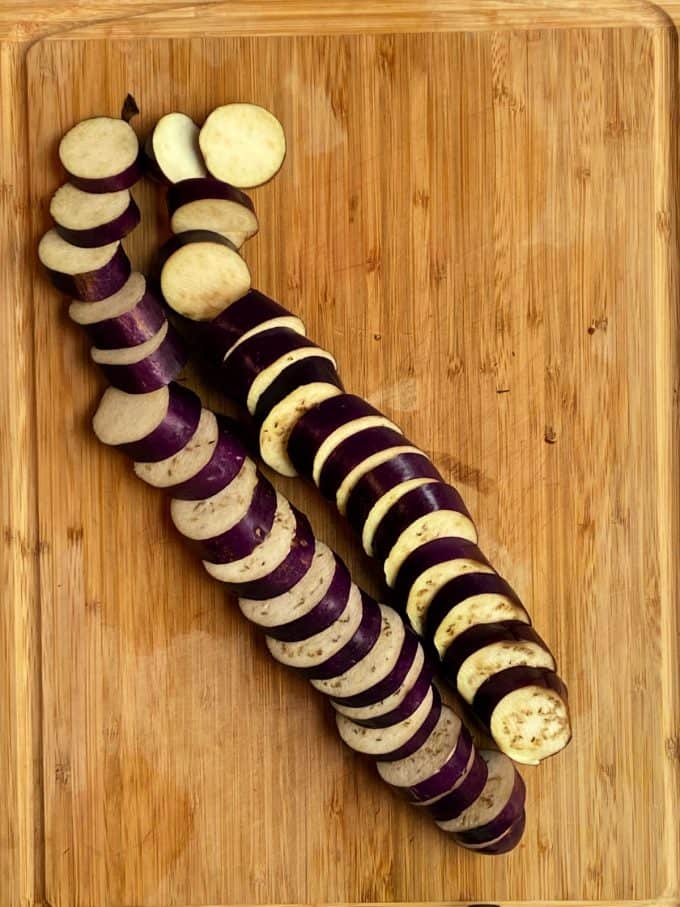 Sliced Japanese / Chinese eggplant on a wood cutting board