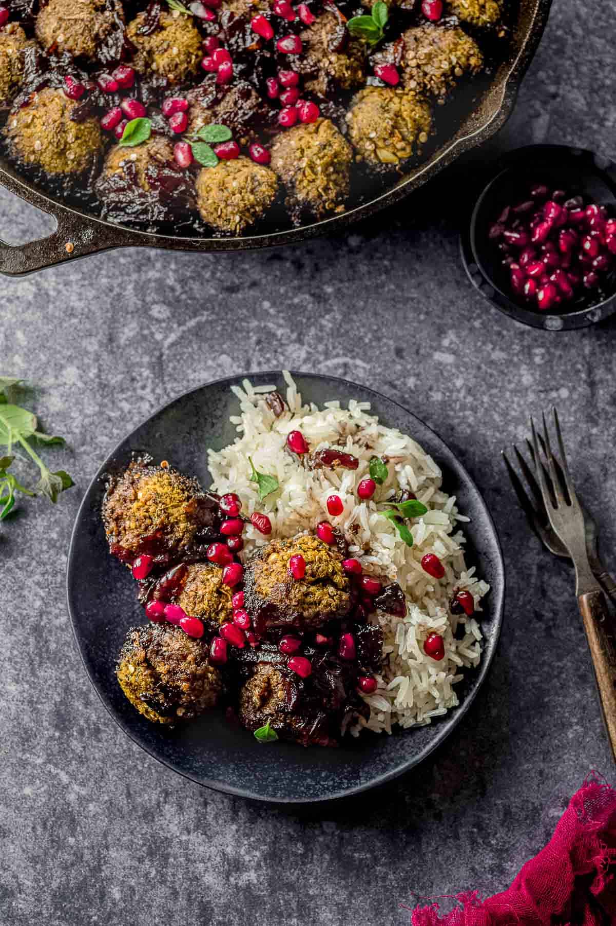 A plate with rice and eggplant meatballs