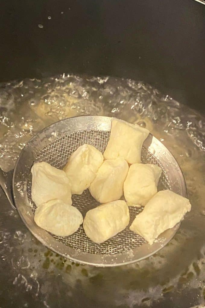 An overhead view of gnocchi in boiling water