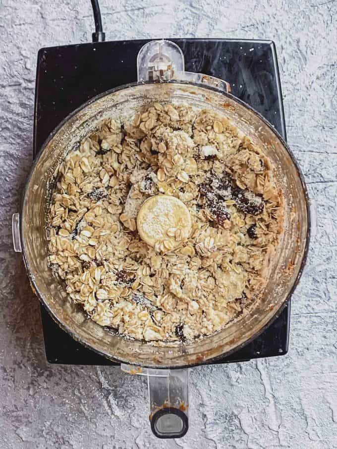 Oatmeal chocolate chip cookie ingredients in a food processor