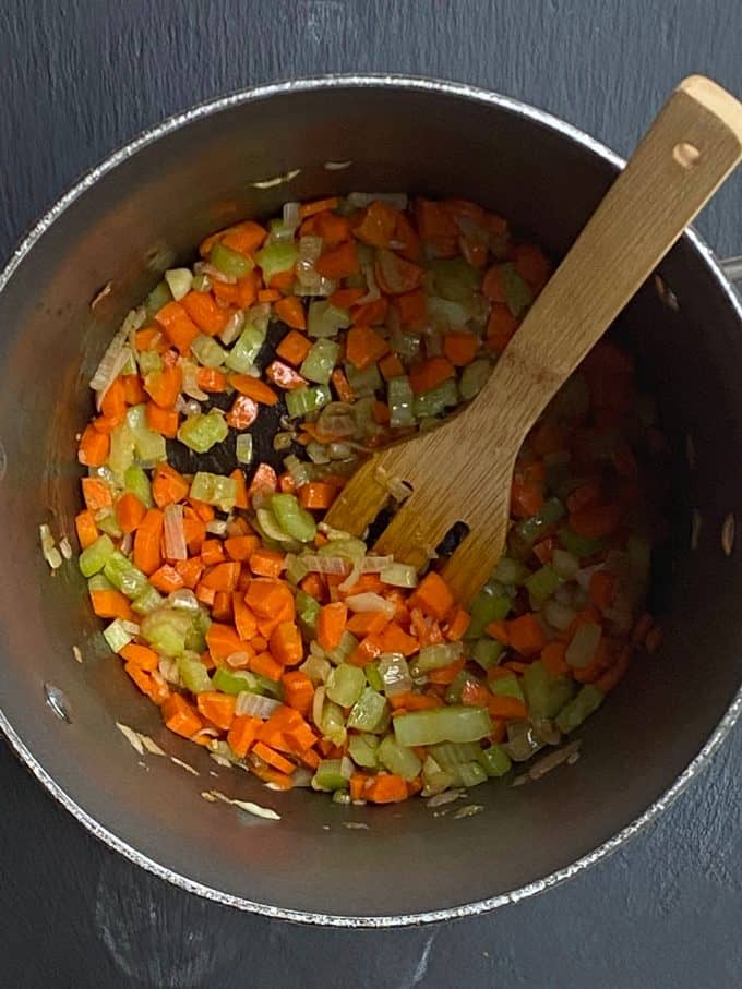 An overhead view of diced vegetables in a pot