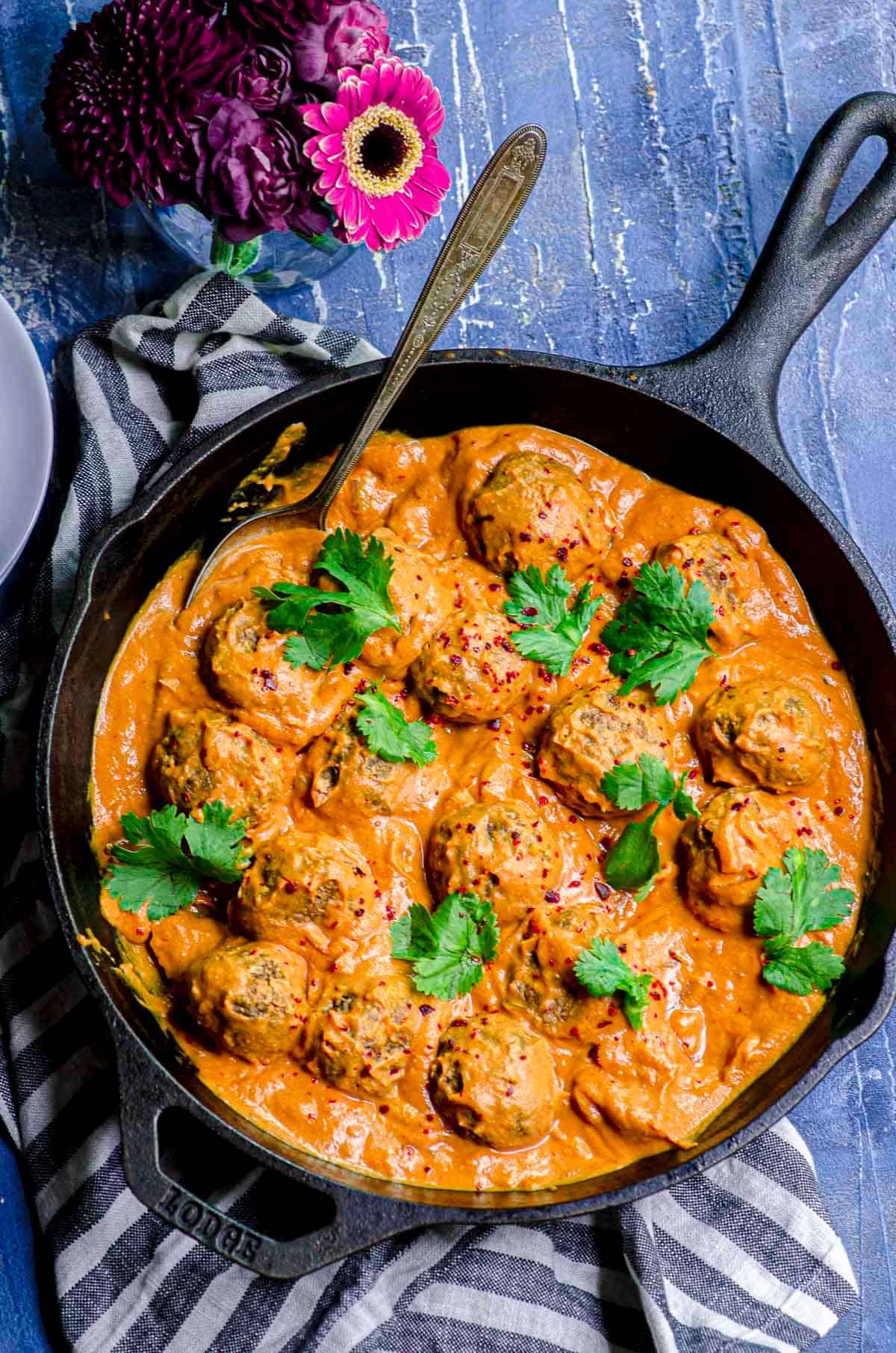 An overhead view of a cast iron skillet with Veggie Meatballs with Pumpkin sauce