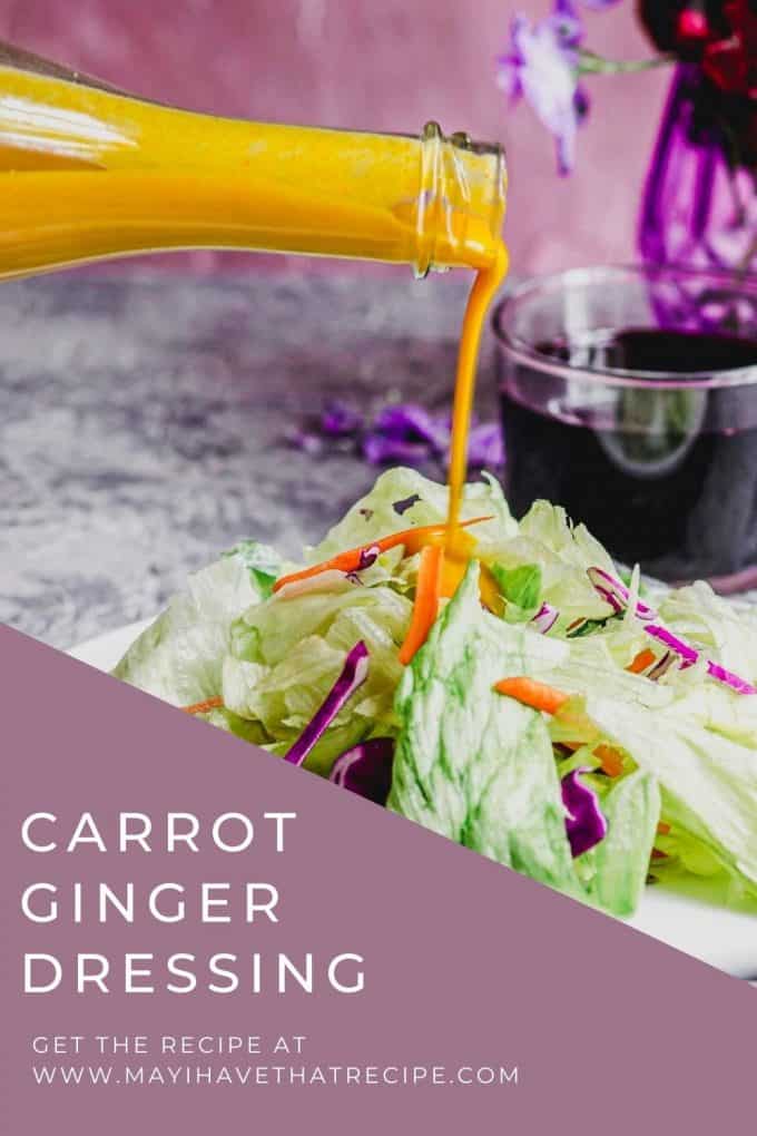 An angled view of a salad with carrot ginger dressing being poured over