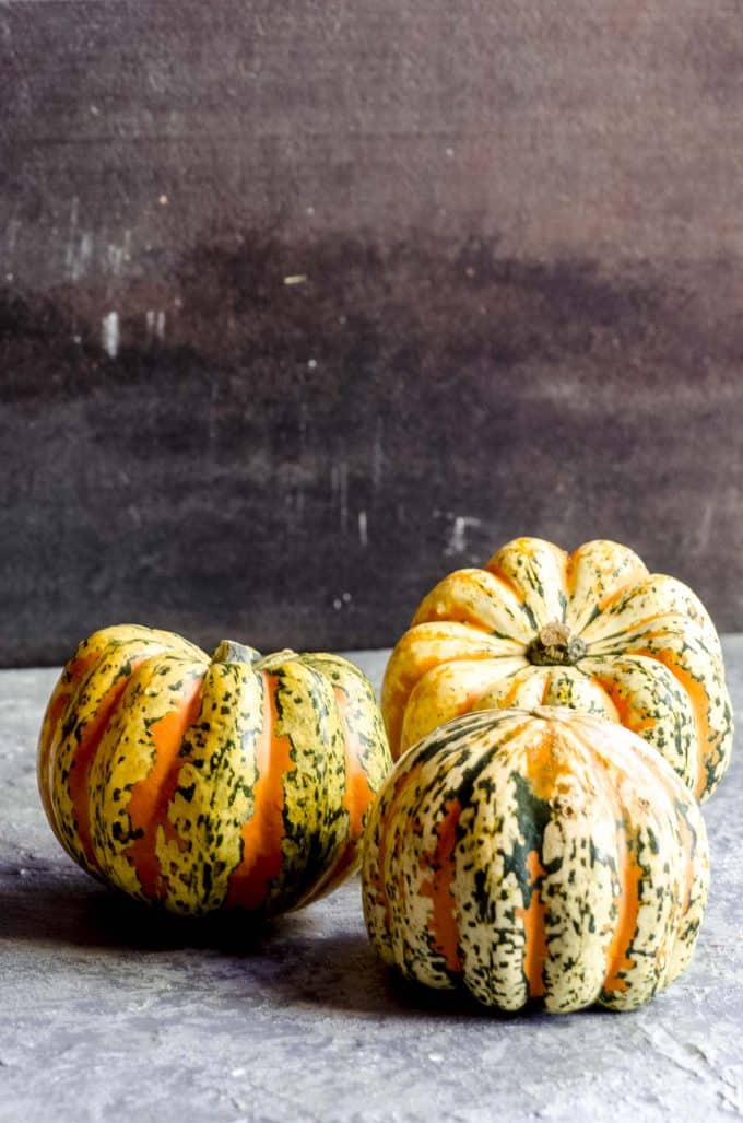 Three carnival squash lined up together
