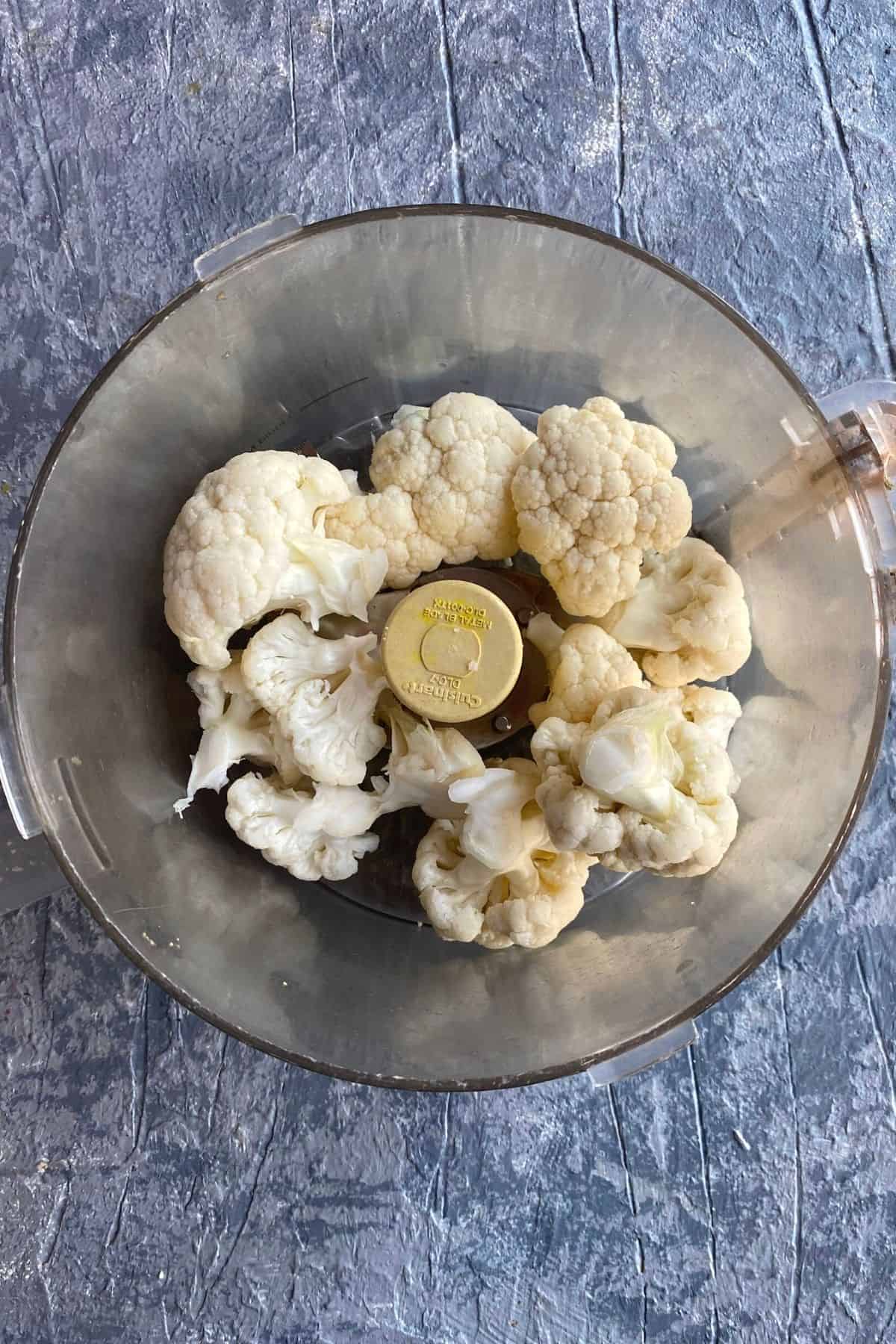Pieces of cauliflower in a food processor