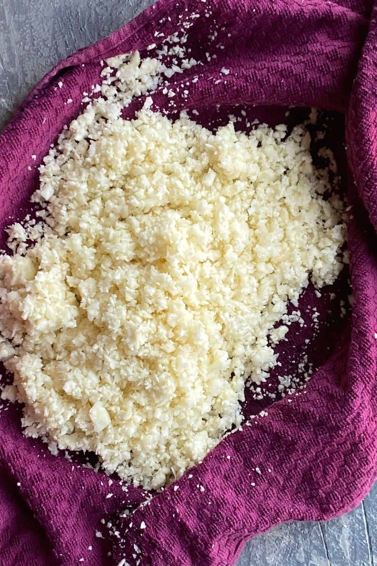 A purple cheesecloth with a pile of cauliflower rice on it
