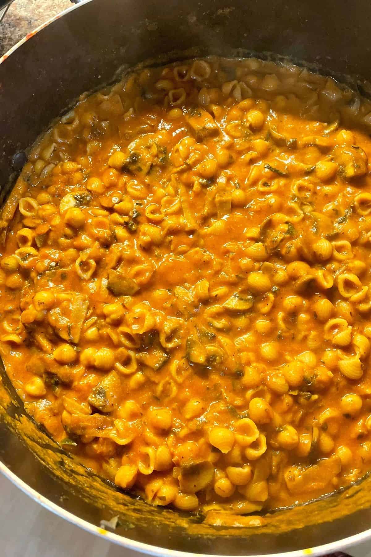 An overhead view of a pot of mushroom and chickpea pasta