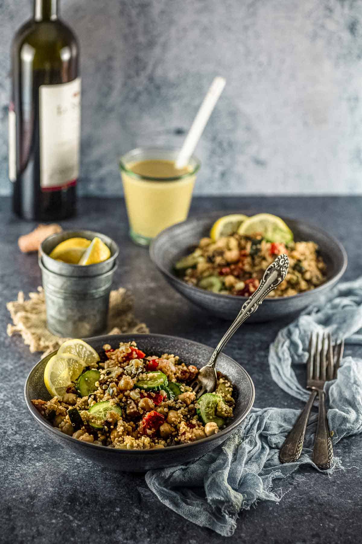 Side view of two bowls of mediterranean quinoa salad