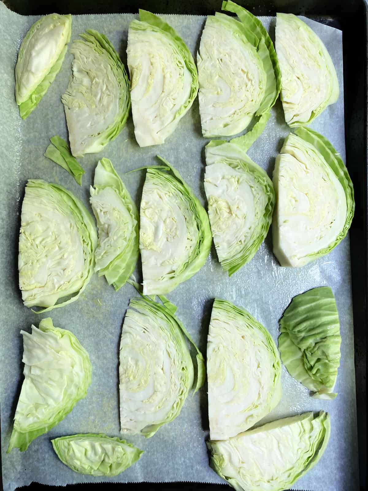 cabbage steaks on a baking sheet