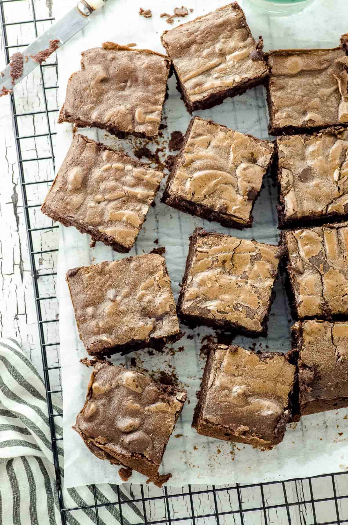 Overhead view of baked chocolate brownies cut into squares and place asymetrically