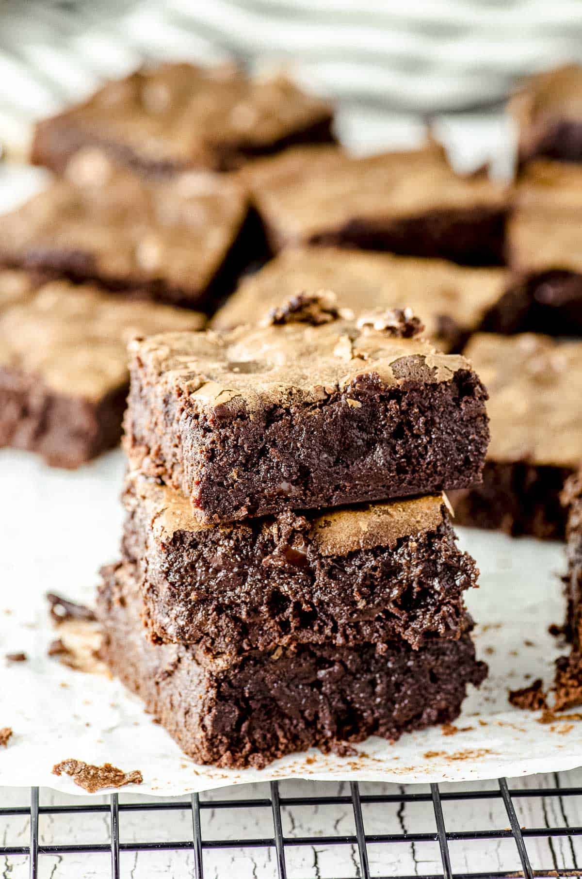 three chocolate brownie squares piled on top of each other