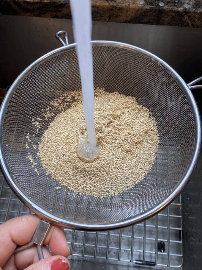 washing quinoa in a colander
