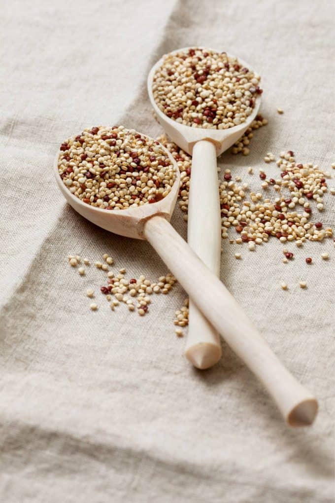 white quinoa in 2 wooden spoons