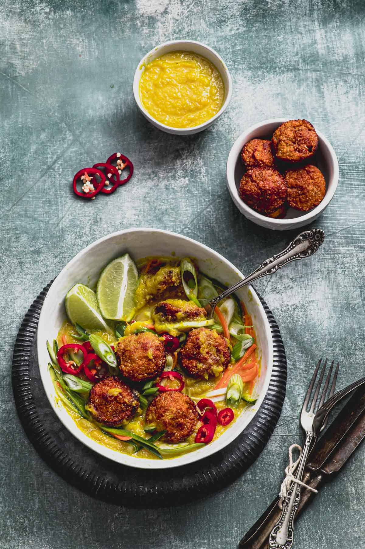 overhead view of a bowl with vegan meatballs in a mango coconut sauce