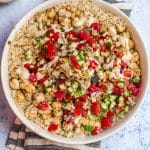 Closeup overhead view of a quinoa bowl topped with Israeli salad