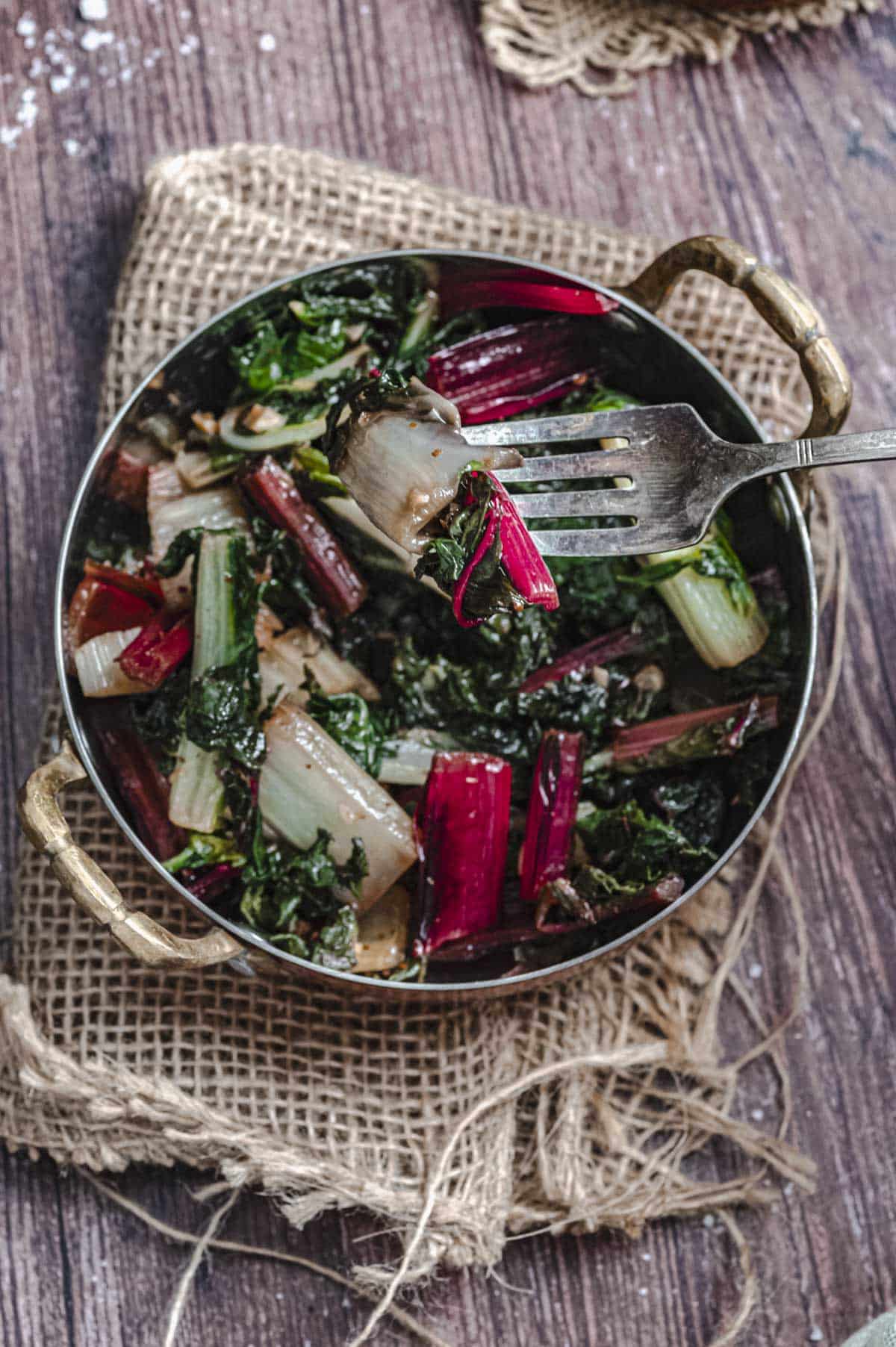 Close up view of a pan with sauteed Swiss chard
