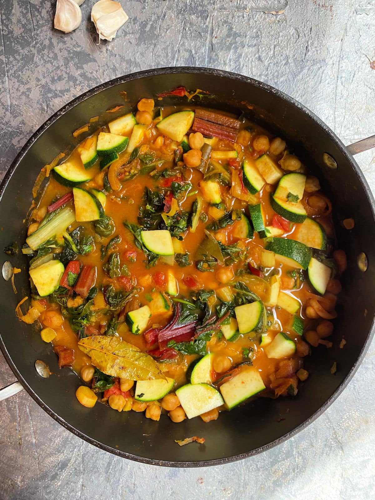 Vegan Stew with Swiss Chard and chickpeas cooking in a pan
