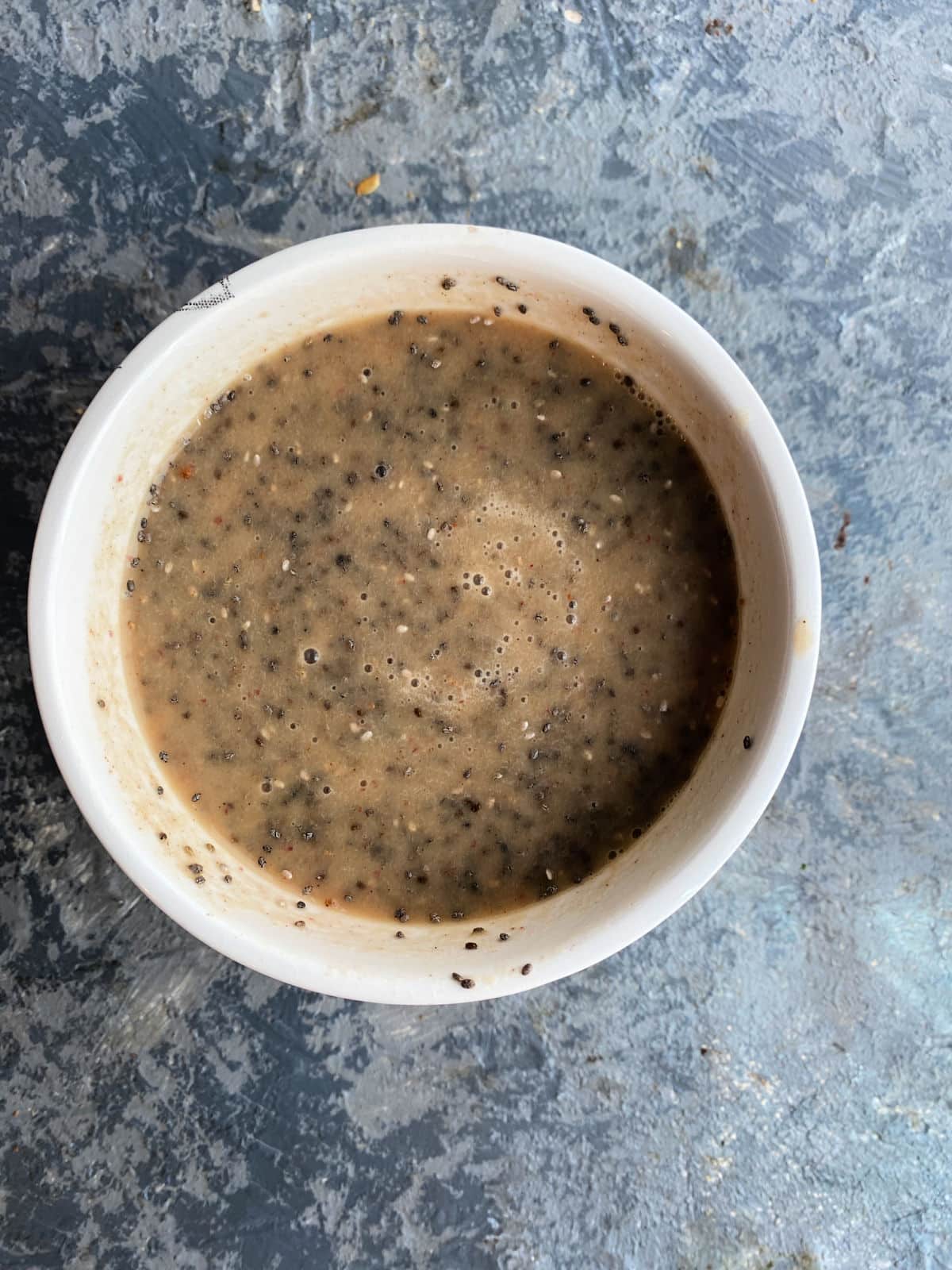 Chia seeds and apple milk mixed in a bowl