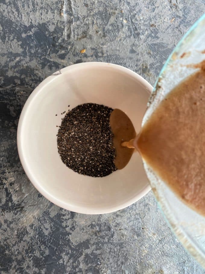 Pouring apple milk mixture into chia seeds