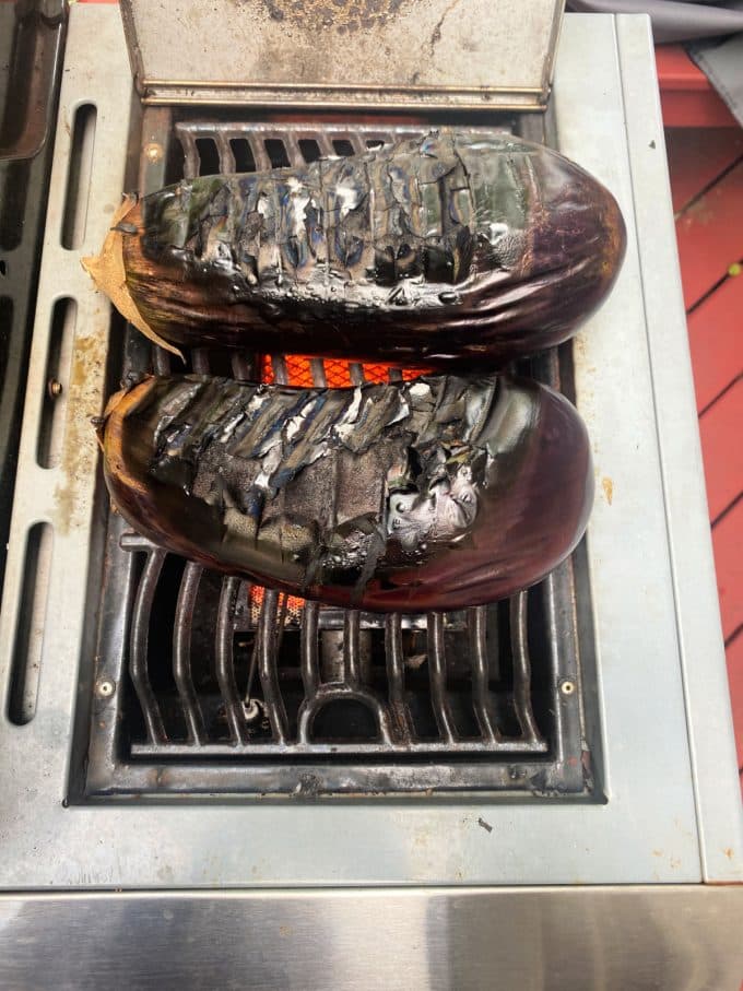 2 eggplant with grill marks on an ourside grill
