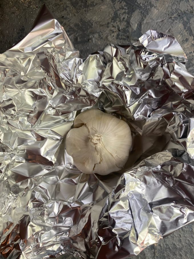 a head of galic about to be rapped in aluminum foil

