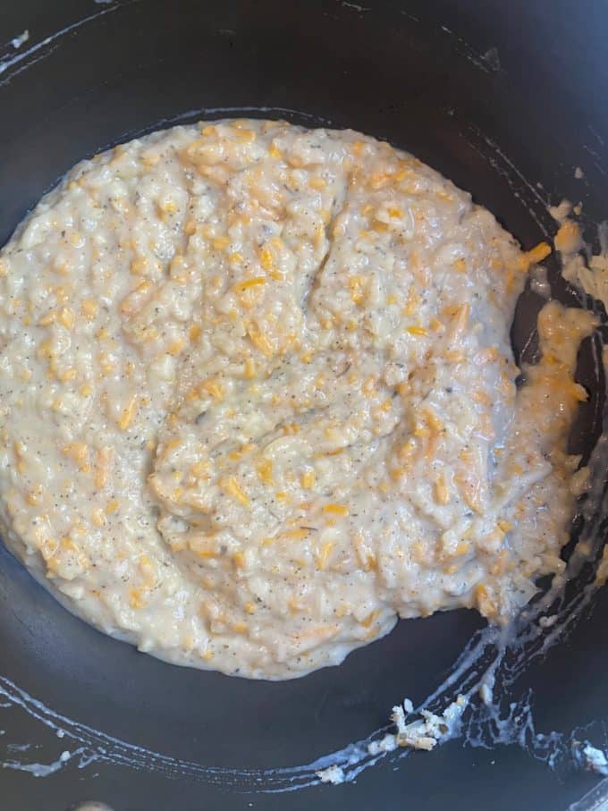 overhead shot of a nonstick skillet with a roux and shredded cheese mixture