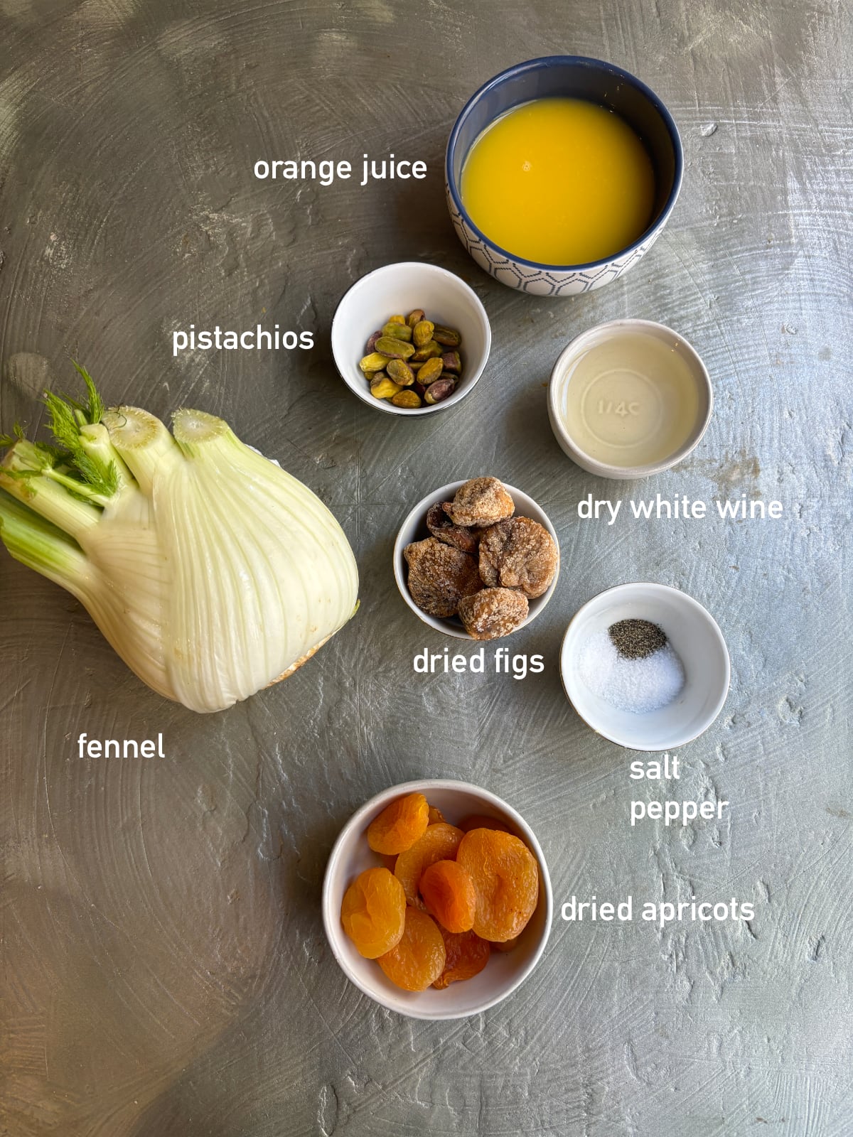overhead shot of the ingredients needed to make braised fennel. The ingredients are in small bowls and each one is labeled. 