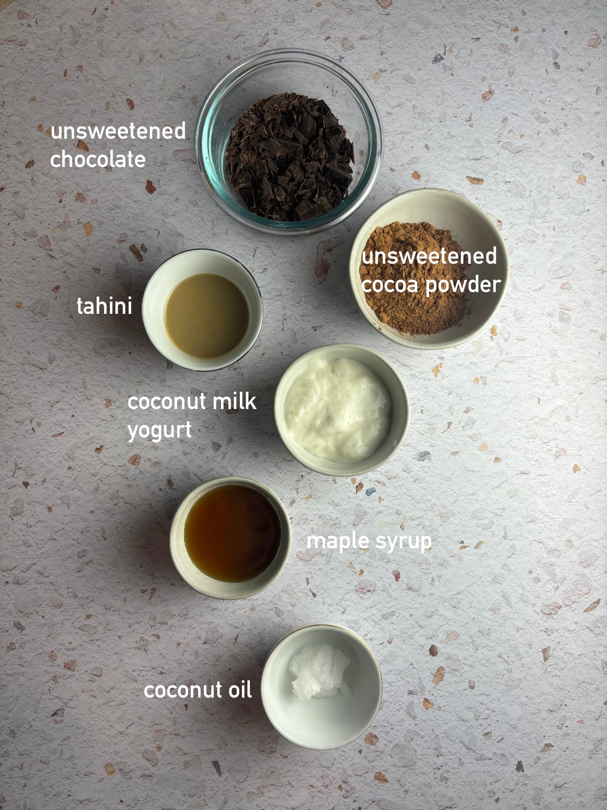 Overhead image of several small bowls each filled with the ingredients to make Vegan Chocolate Truffles