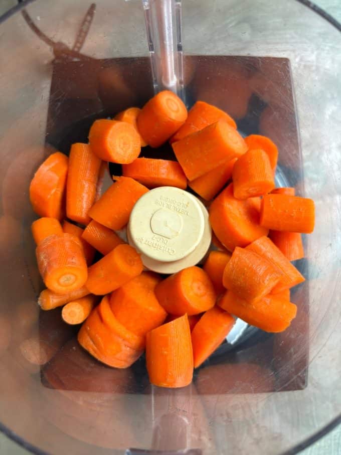 overhead image of chopped carrots in a food processor