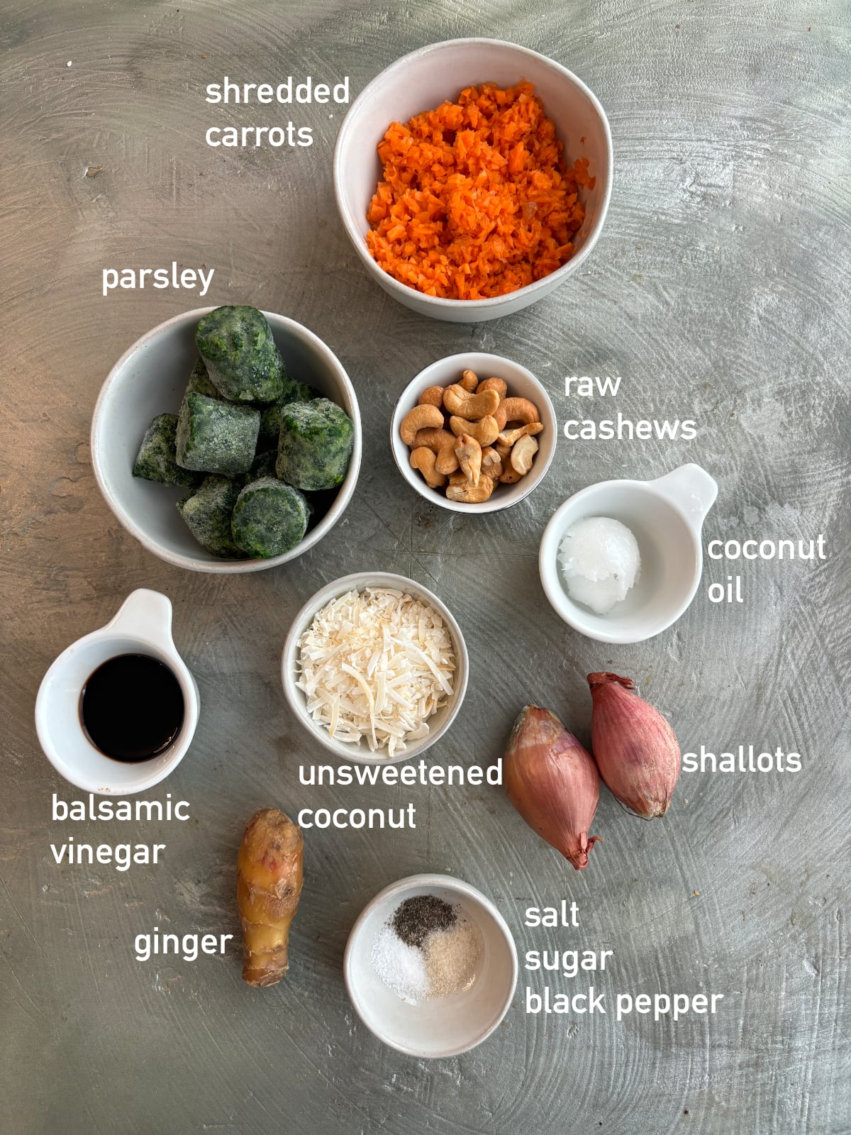 overhead image of the ingredients needed to make carrot rice. Each ingredient is in a small white bowl.
