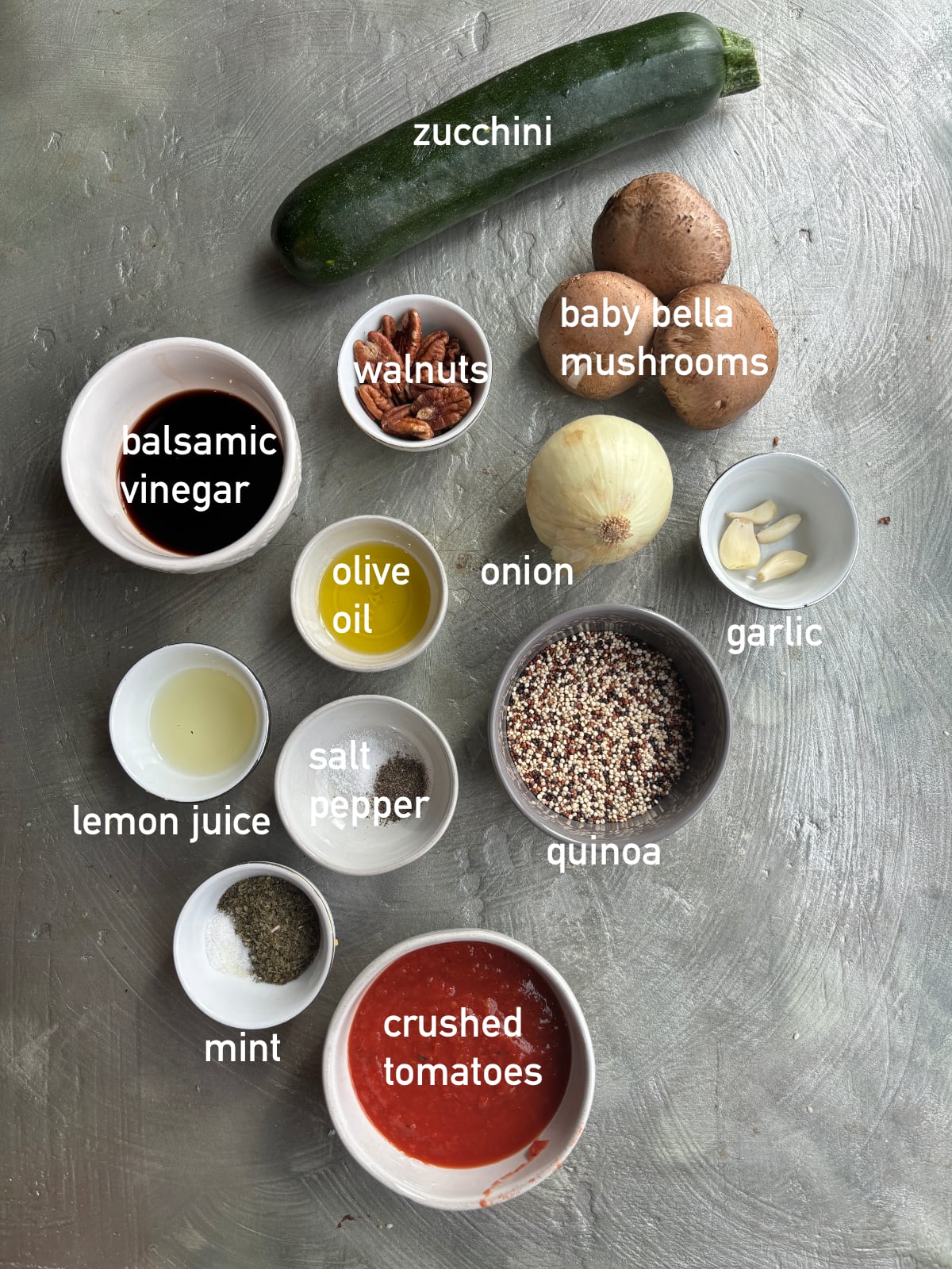 overhead image of the ingredients needed to make quinoa boats. Each ingredient is in a small white bowl and labeled with white text.